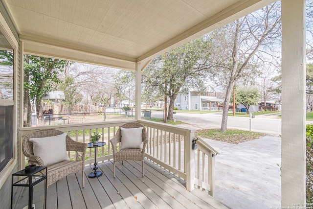 wooden deck with a porch and a residential view