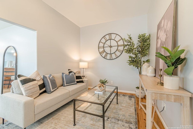 living area with wood finished floors and baseboards