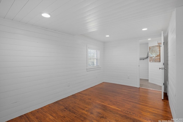 spare room with dark wood-style flooring and recessed lighting