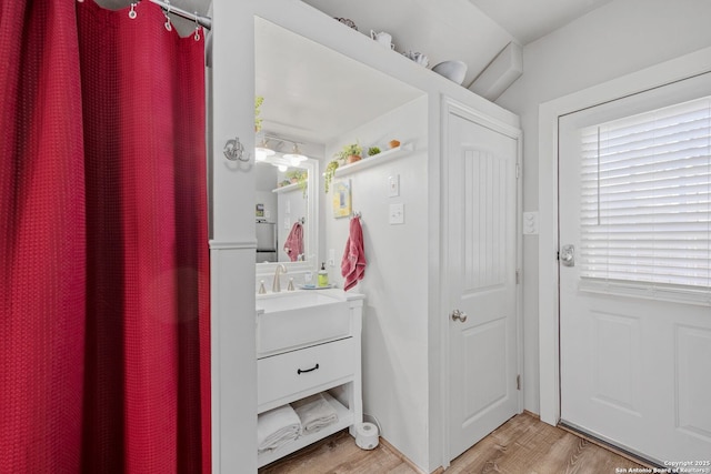 bathroom with wood finished floors and vanity