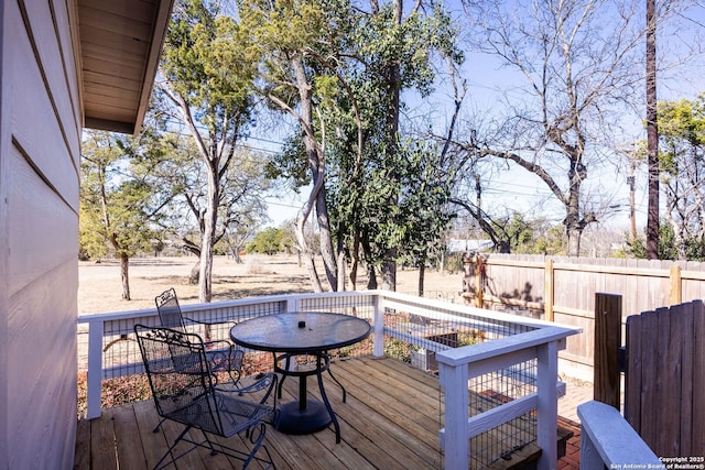 wooden terrace with fence and outdoor dining area