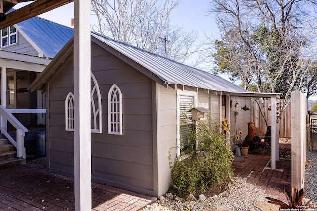 view of outdoor structure with an outbuilding and fence