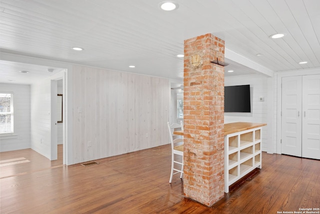 unfurnished living room featuring wood finished floors, visible vents, and recessed lighting