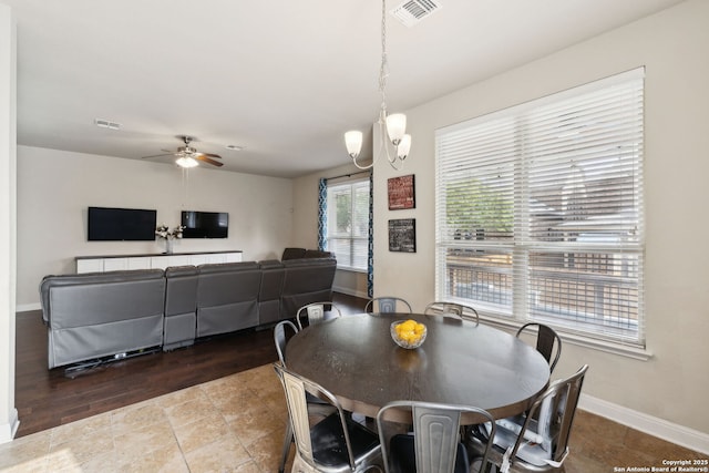 dining room with visible vents, baseboards, and ceiling fan with notable chandelier