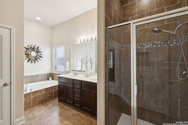 bathroom with a garden tub, a sink, and a shower stall