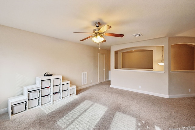 spare room with carpet, ceiling fan, visible vents, and baseboards