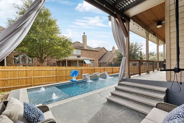 view of pool featuring fence, a fenced in pool, and a ceiling fan