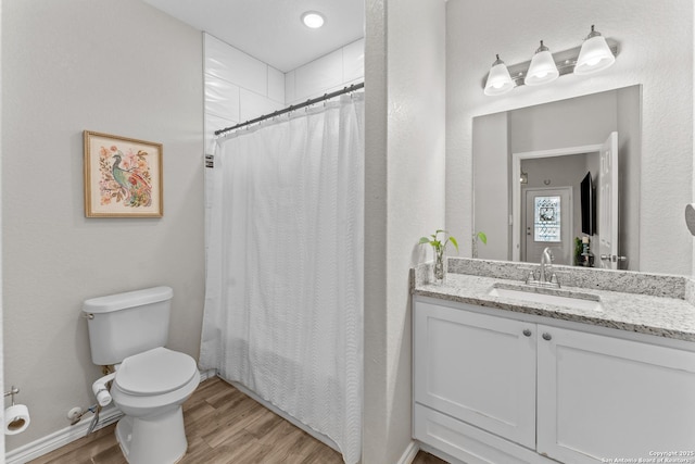 full bathroom with a shower with curtain, vanity, toilet, and wood finished floors