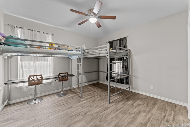 bedroom with baseboards and wood finished floors