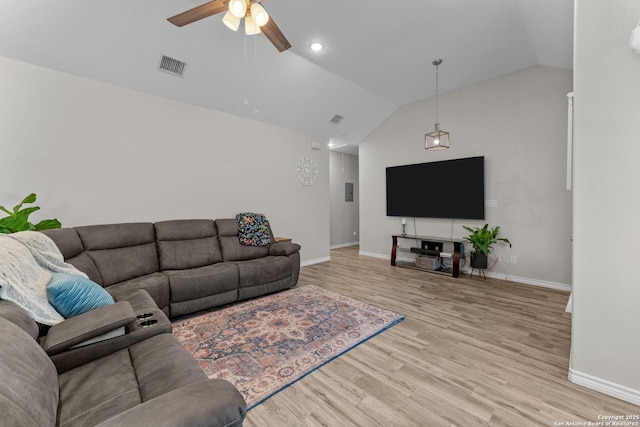 living area featuring baseboards, visible vents, a ceiling fan, lofted ceiling, and light wood-type flooring