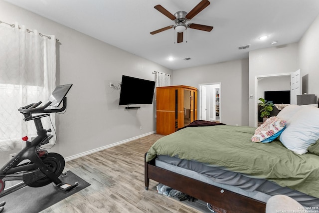 bedroom with baseboards, visible vents, wood finished floors, and recessed lighting