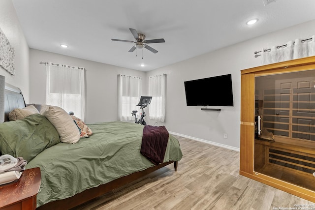 bedroom with recessed lighting, light wood-style floors, a ceiling fan, multiple windows, and baseboards