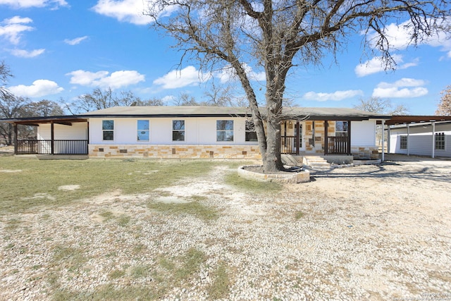 view of front of property with stone siding and covered porch