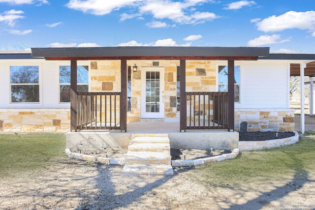 620 County Road 6846, Lytle, TX 78052 - view of front of property with stone siding and covered porch