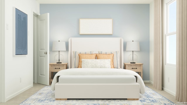 bedroom with light colored carpet and baseboards