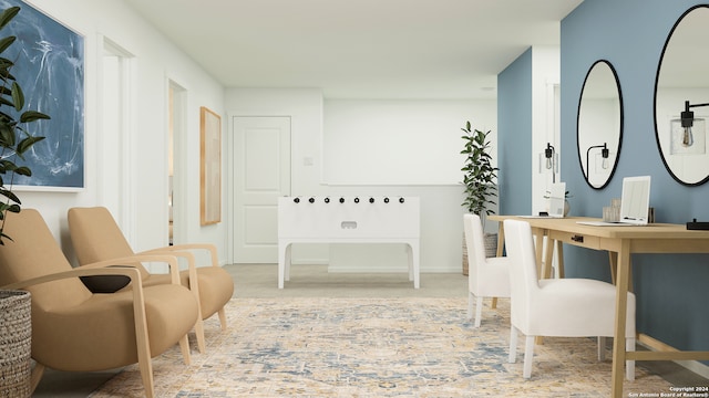 sitting room featuring baseboards and carpet flooring