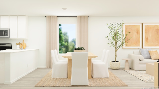 dining area featuring light wood-type flooring and baseboards