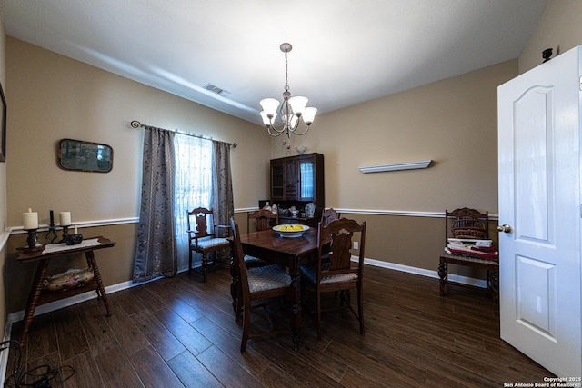 dining room with baseboards, visible vents, a chandelier, and dark wood-type flooring