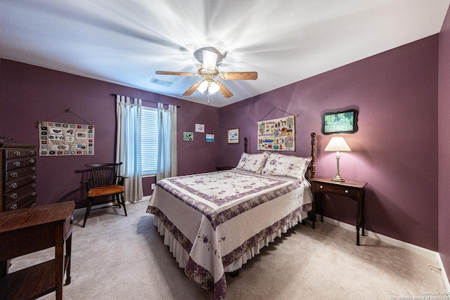 bedroom with baseboards, visible vents, a ceiling fan, and light colored carpet