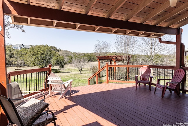 deck featuring fence and a pergola