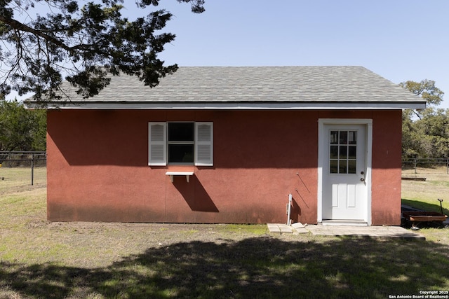 view of outbuilding featuring fence