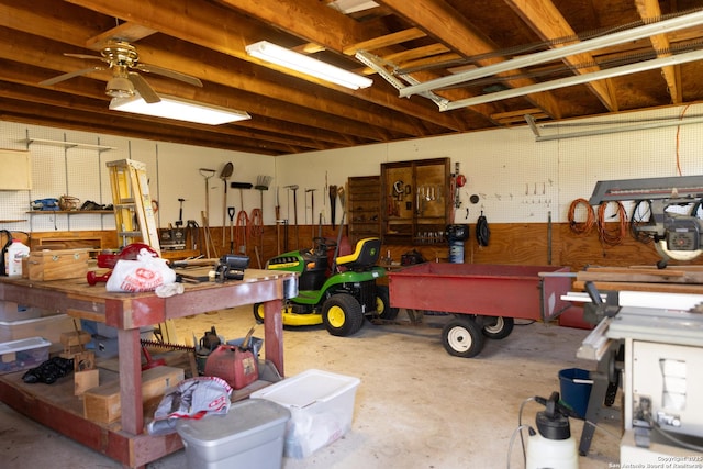 garage with ceiling fan and a workshop area