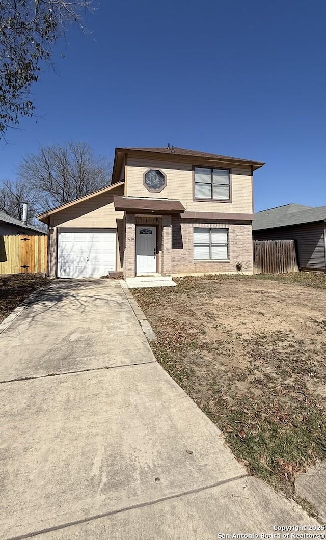 view of front facade with an attached garage, fence, concrete driveway, and brick siding