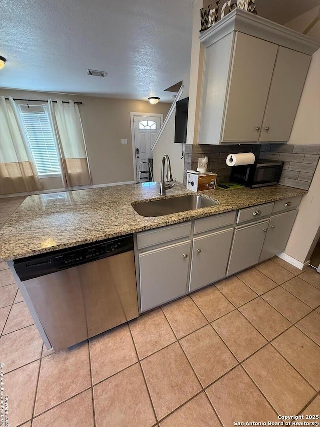 kitchen featuring visible vents, a healthy amount of sunlight, stainless steel dishwasher, black microwave, and a sink