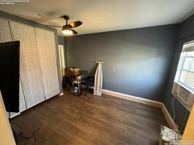 bedroom with a ceiling fan, cooling unit, baseboards, and wood finished floors