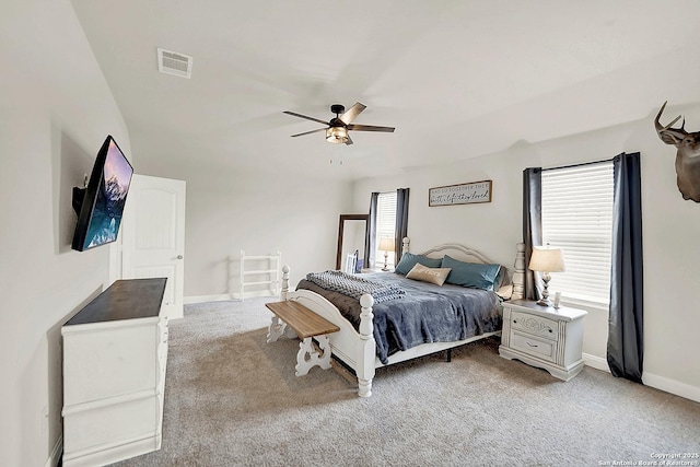 bedroom featuring visible vents, light carpet, baseboards, and multiple windows