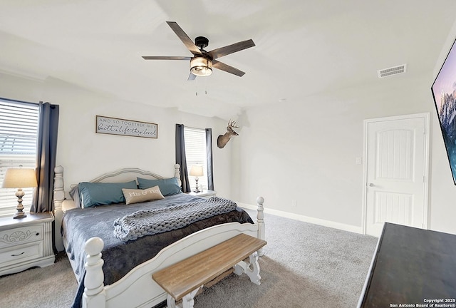 bedroom with carpet floors, a ceiling fan, visible vents, and baseboards