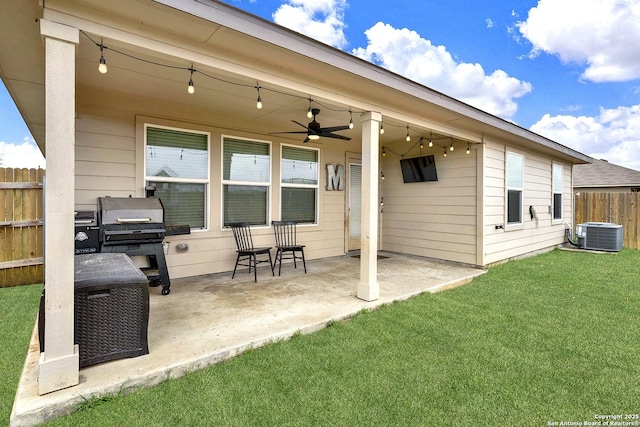 rear view of property featuring central AC unit, a patio area, fence, and a ceiling fan