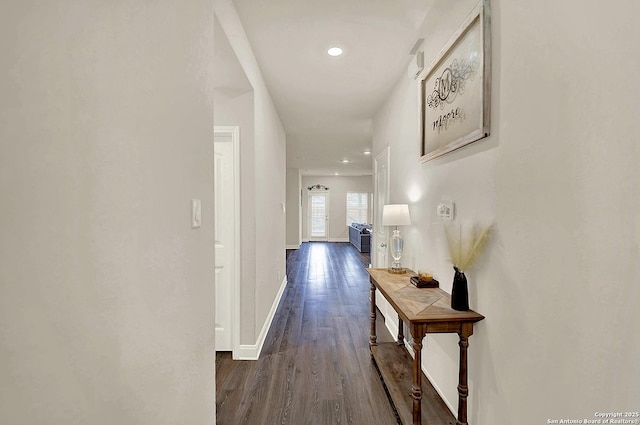 corridor with recessed lighting, dark wood-style flooring, and baseboards