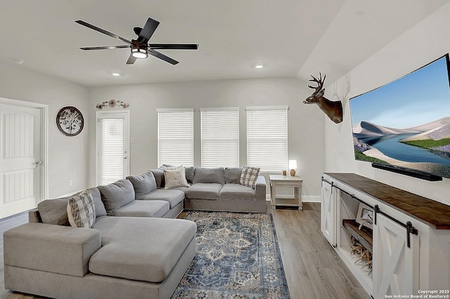 living room with light wood-style floors, ceiling fan, baseboards, and recessed lighting