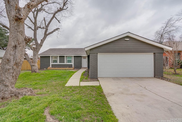 single story home featuring a garage, a front yard, concrete driveway, and brick siding