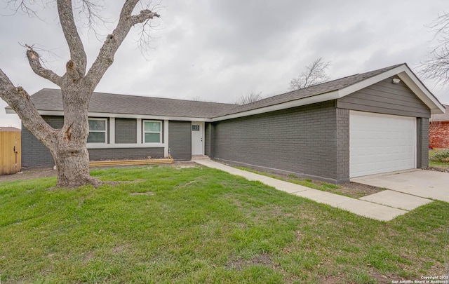 ranch-style home with an attached garage, a front yard, concrete driveway, and brick siding