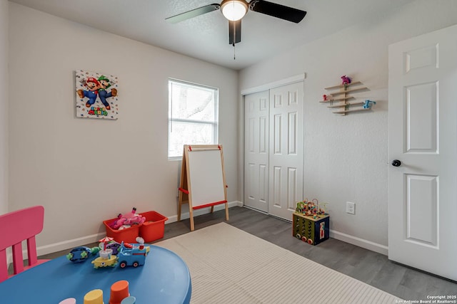 game room with ceiling fan, baseboards, and wood finished floors