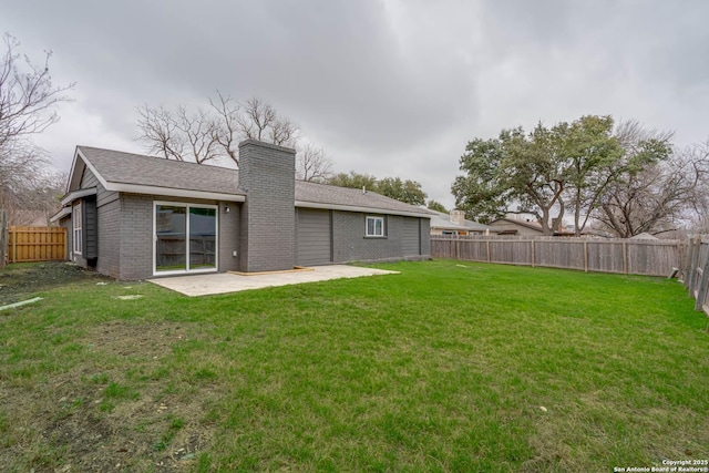 back of house with brick siding, a fenced backyard, a yard, and a patio