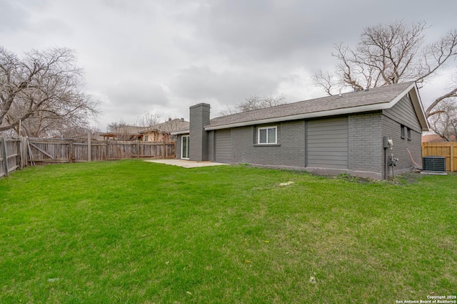 view of yard with a fenced backyard, cooling unit, and a patio