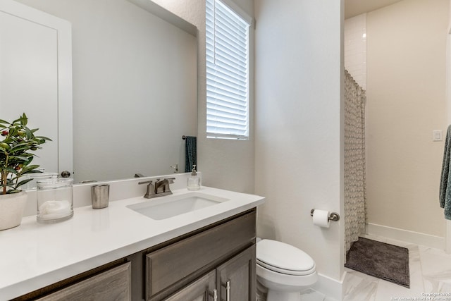 bathroom featuring marble finish floor, curtained shower, toilet, vanity, and baseboards