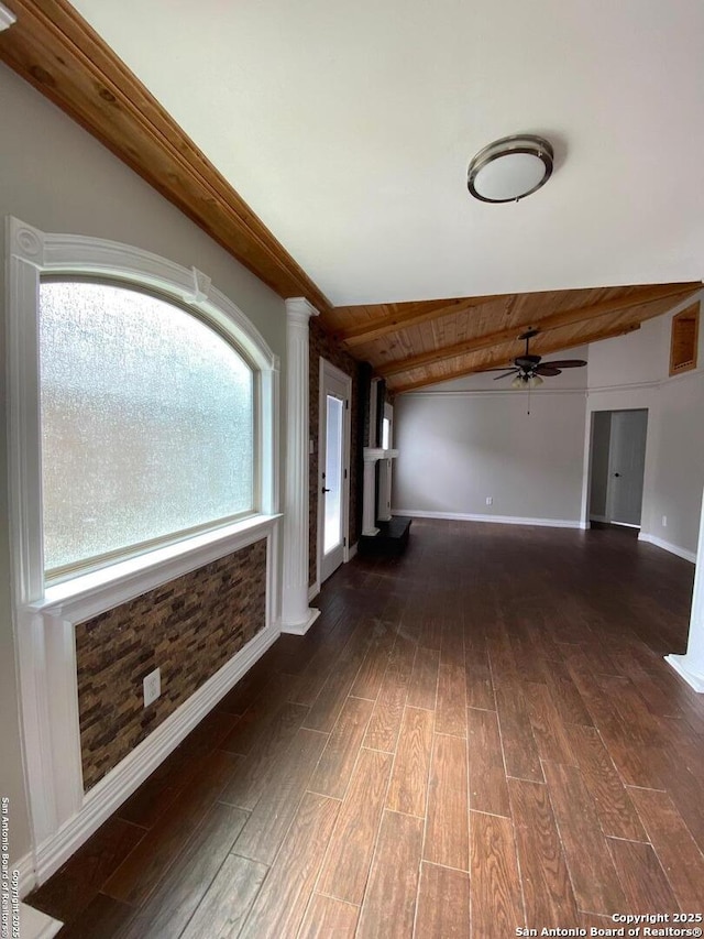 unfurnished living room with wooden ceiling, baseboards, lofted ceiling with beams, and dark wood-style flooring