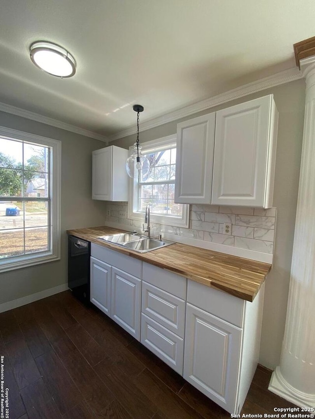 kitchen featuring wooden counters, decorative backsplash, dark wood-type flooring, a sink, and dishwasher