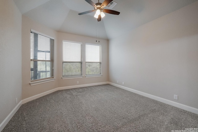 spare room with a healthy amount of sunlight, visible vents, vaulted ceiling, and baseboards