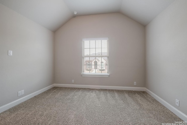 additional living space with lofted ceiling, baseboards, and carpet