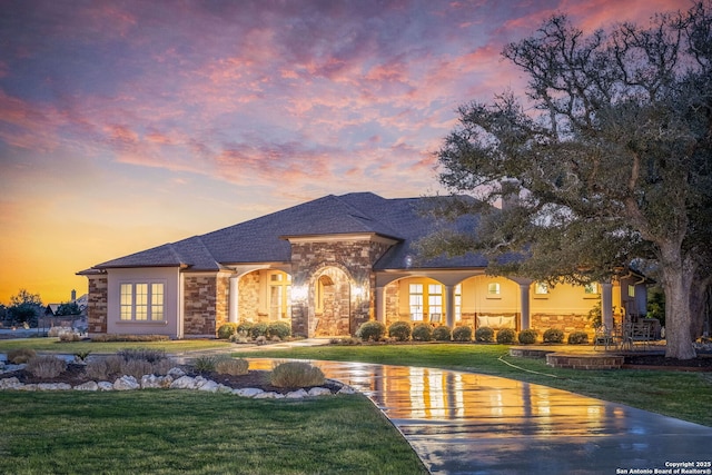 view of front facade featuring stone siding and a front yard