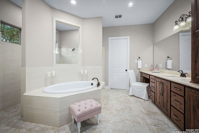 full bathroom with visible vents, a garden tub, walk in shower, vanity, and recessed lighting