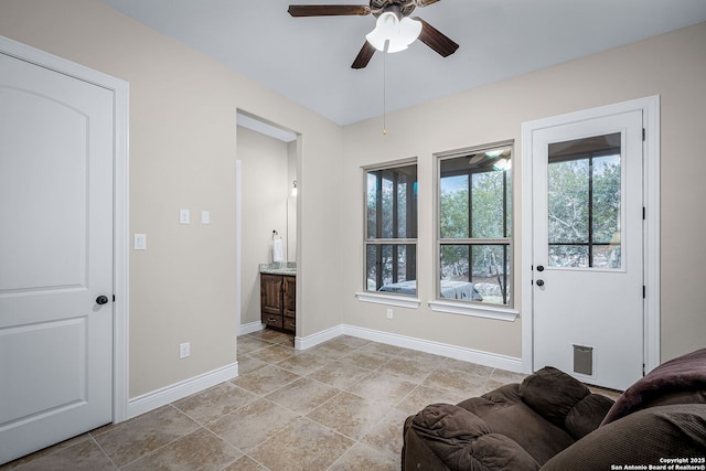 sitting room featuring baseboards and a ceiling fan