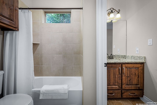 bathroom with toilet, shower / bath combo, baseboards, and vanity