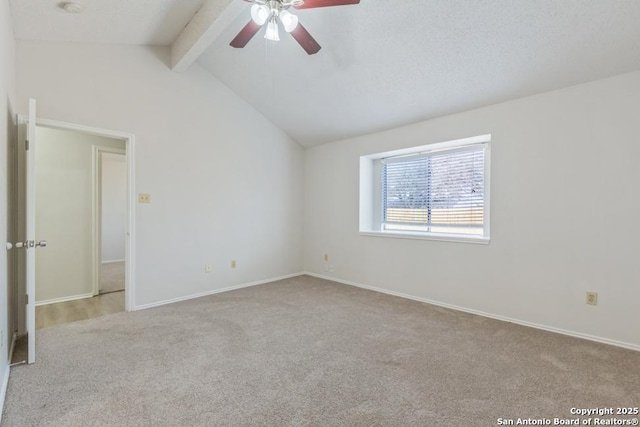 carpeted empty room featuring lofted ceiling with beams, baseboards, and a ceiling fan