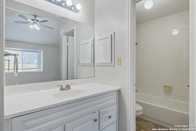 full bath with a ceiling fan, toilet, tile patterned flooring, vanity, and shower / bathing tub combination